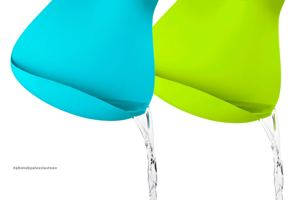 Advertising photo of two silicone products, turquoise and lime green, with water pouring from their tips