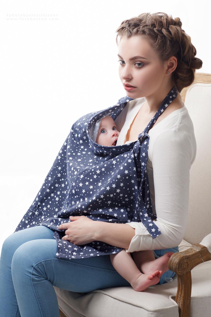 Family portrait of a mother holding her baby in a bright studio setting