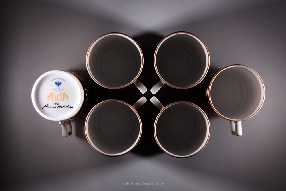 Overhead product photo of five porcelain cups arranged symmetrically