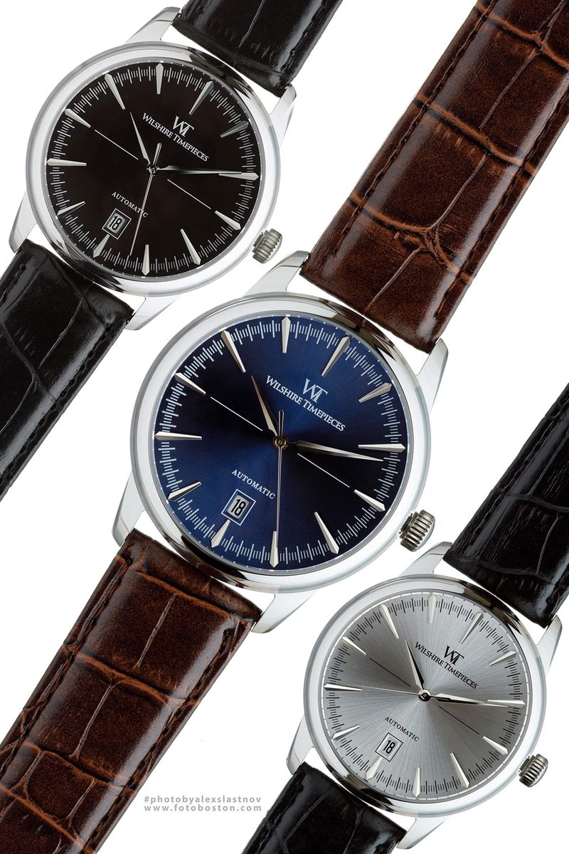 Commercial product photography of three automatic wristwatches with leather straps on a white background